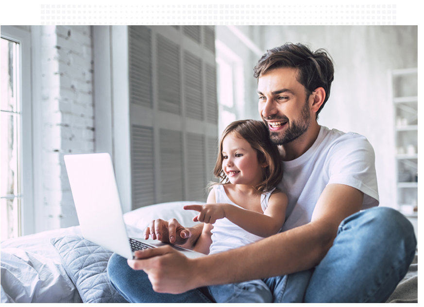 FIU Online male student studying at home with his child in his lap